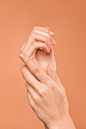 Persons Hand on Orange Background