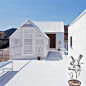 House in Yamasaki with rooftop sheds by Tato Architects