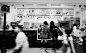 2 Women Standing Infront Hello Kitty Themed Store in Greyscale Photography