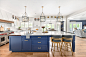 Inspiration for a huge transitional u-shaped vinyl floor and brown floor eat-in kitchen remodel in Milwaukee with a farmhouse sink, shaker cabinets, blue cabinets, quartzite countertops, white backsplash, subway tile backsplash, stainless steel appliances