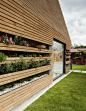La Leroteca / Lacaja Arquitectos, green wall, garden in wall, flowers on facade, wood exterior wall, kindergarten