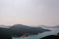 lake beside mountains during daytime