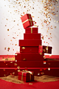 Red box with gold confetti and confetti coming down steps, in the style of indoor still life, simplified compositions, wrapped, piles/stacks, crisp and clean, commercial imagery, spiral group