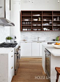 The ceiling and exposed ductwork is painted white for a fresh look. | Photographer: Valerie Wilcox