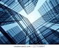 View of high rise glass building and dark steel window system on blue clear sky background,Business concept of future architecture,looking up to the sun light on the top of building. 3d render