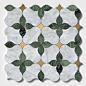 This may contain: a white and green tile with leaves on the bottom, gold trimmings around it
