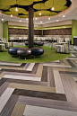 Bright pops of green floor covering enliven this corporate office space and add texture to the floor plane.: 