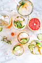 Macro view of the top of cocktail drinks with sliced cucumber and grape fruits