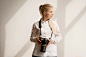 woman-holding-camera-photo-looking-away_23-2148565518