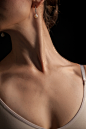 close-up-young-woman-s-neck-dark-background