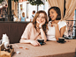 two-young-beautiful-smiling-hipster-girls-trendy-summer-casual-clothes-carefree-women-chatting-veranda-terrace-cafe-drinking-coffee-positive-models-having-fun-communicating_158538-15933