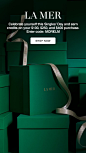This may contain: a green box with a silver ribbon on it and the words la merr written in gold