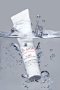 This may contain: a tube of gel sitting on top of a body of water with bubbles around it