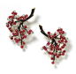 Boucheron | Brooches in the form of cascading cherry blossom, the stems enamelled black bearing brilliant-cut diamond and cabochon ruby-set flowers.     Paris. c.1920.
