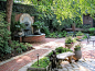 Inspiration for a mid-sized timeless backyard brick patio fountain remodel in Atlanta with no cover