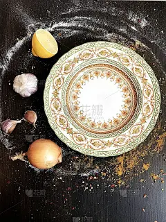 一个漂亮的东方盘子放在用香料装饰的黑色桌子上。