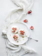 Small strawberry and pistachio pavlova meringue cakes with mascarpone cream, fresh mint over white b by Anna Ivanova on 500px