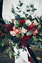 Deep reds and jewel tone berries complete this festive wintery bouquet from Fairley's Bespoke Floristry.