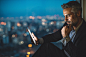 Businessman looking at digital tablet at night