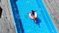 top view of barefoot woman swimming on swim ring i