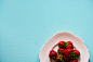 flat lay photography of bunch of strawberries on white plate