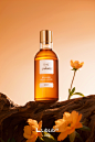 01896-1505520648-flower,still life,Without humans,Realistic,orange background,white flower,blurry,english text,scenery,bottle,gradient background