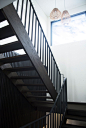 A contemporary dark wood staircase leads you upstairs and a large window floods the space with natural light.