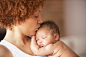 Profile of mother kissing sleeping baby on head by Gable Denims on 500px