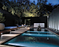 Sleek contemporary pool and landscape with Buddha feature. Nice accent lighting too. Pinned to Pool Design by BASK Pool Design.