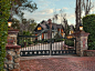Set behind stately iron gates and tall hedging sits this English country style home within the Pepper Hill area of Montecito. #fence #brick #dreamhome