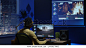 Medium shot of a young man editing video inside the modern video studio while his colleagues are giving instructions