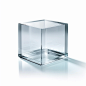 a solid glass cube on a completely white background