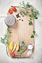 Kitchen utensils, spices and herbs for cooking fish on cutting b by ImagineIsle  on 500px