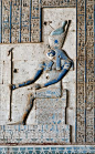Horus in Dendera.  A relief in the Hathor Temple at Dendera shows Horus of Edfu, sitting on a throne and wearing the com...: 