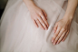 Free photo bride hands with manicure on her dress