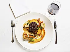 Looking down at delicious steak meal served with red wine