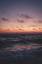 ocean waves under cloudy sky during sunset