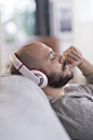 Hispanic man listening to headphones - stock photo