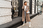 Fashion street portrait of stylish european brunette woman in leather coat posing outdoor