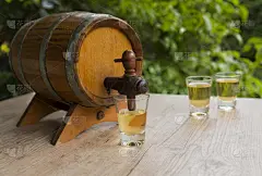 Brazilian drink Caipirinha ingredient: Cachaça in a barrel and a shot glasses