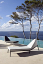 Interesting chair design overlooking beautiful infinity pool and vast blue ocean. Heaven!