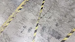 工业地坪陈旧，表面带胶带水泥混凝土灰色背景，用于卷筒纸和印刷