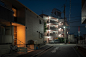 Rising in the Dark III : From dusk till dawn, from Tokyo to Fukuoka passing from Osaka, the Japanese outskirt's landscape always looks similar to itself. In the endless suburbia the clean little cars, the silent streets, the precise order of the parking l