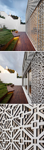 The rear of this house is covered in a white artistic screen inspired by traditional Portuguese tiles, to allow sunlight to filter through to the interior of the home and to provide added security.