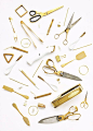 I like the photo layout of gold items ranging from scissors, clip binders, paper clips, forks and stirrers.: 