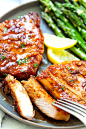 Sliced pork chops with honey garlic sauce with a fork, ready to be eaten. 