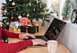 Business woman working on computer in christmas day with gift box and christmas tree background