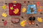 Women's autumn outfit on wooden background