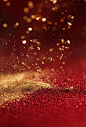 Red background, golden border, gold particles floating in the red liquid with space for text in the center, a luxurious and elegant style, a festive atmosphere, high resolution, macro photography, minimalist composition, cinematic lighting, natural light