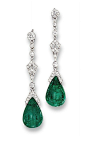 A PAIR OF BELLE EPOQUE EMERALD AND DIAMOND EAR PENDANTS, BY CARTIER Each suspending an emerald drop to the rose-cut diamond cap and kite-shaped panel with diamond collet connecting links and circular-cut diamond surmount, circa 1915, 4.3 cm long, in fitte